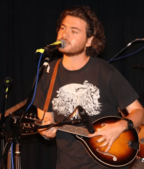 Paddy Phillips Musician - playing guitar and singing on stage