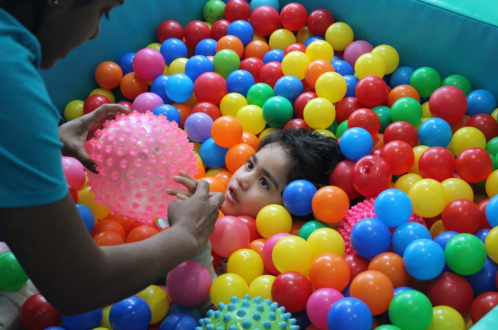 Boy in ball pit during Occupational Therapy at CPotential