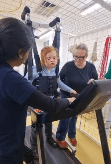 Stanley using the LiteGait on the Treadmill in Physiotherapy CPotential, with therapist and mum